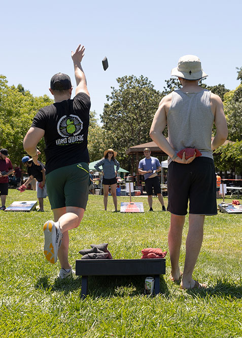 Two people playing in the EWB Sonoma Chapter Cornhole Tournament