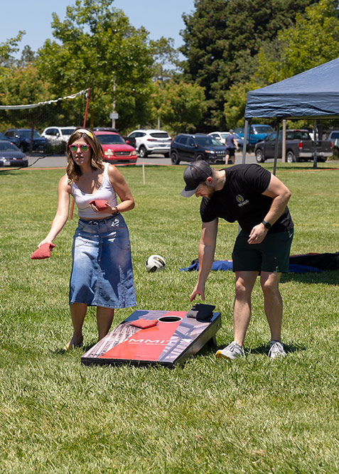 Two people playing in the EWB Sonoma Chapter Cornhole Tournament