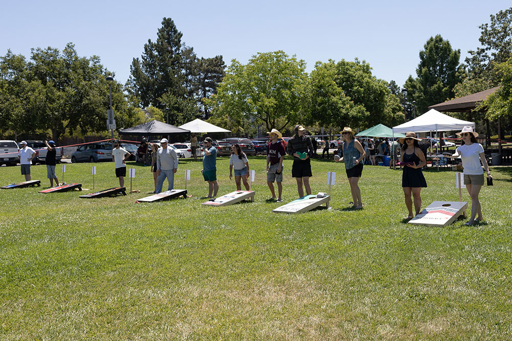 A row of teams playing in the EWB Sonoma Chapter Cornhole Tournament